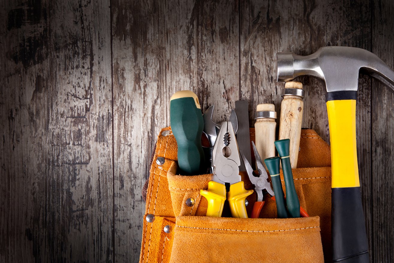 set of tools in tool box on a wooden background